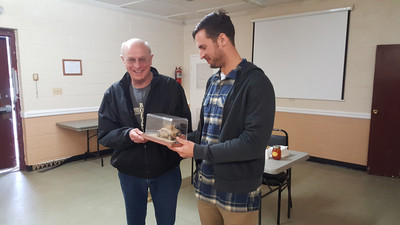 Larry Mason presenting a model to his son who served in Iraq with a Humvee like he used during his deployment
